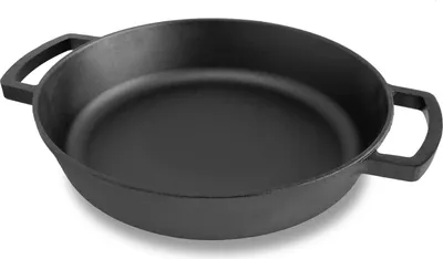A black cast iron pan with two handles is shown from a slightly elevated angle against a white background.