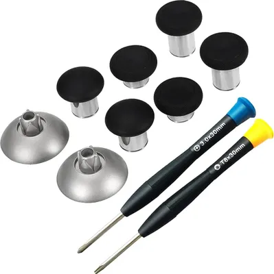 A collection of gaming accessories, including thumbstick grips and screwdrivers, laid out on a white background.