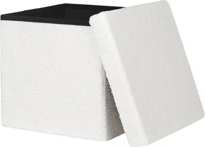 A white storage ottoman with its lid open, revealing a black interior.