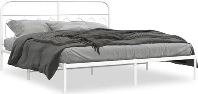 A white metal bed frame with a headboard, dressed with gray bedding and a dark gray blanket.