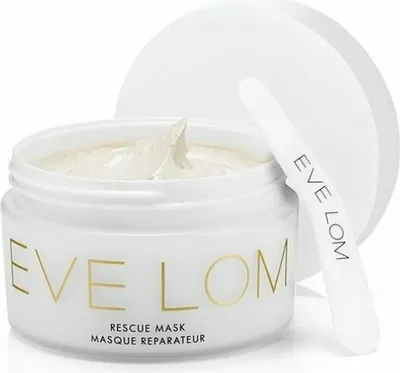 A white jar of Eve Lom Rescue Mask with a spatula resting on the lid.