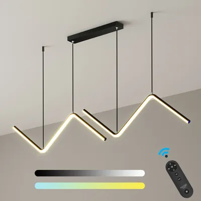 A modern LED pendant light with a zigzag design, suspended from a black ceiling mount. The light is illuminated with a warm white glow, and a remote control is shown in the lower right corner, along with color gradient bars indicating adjustable color temp