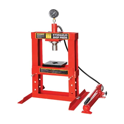 A red hydraulic shop press with a pressure gauge and a separate hydraulic pump.