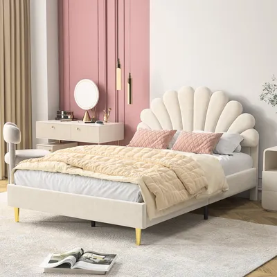 A bedroom scene featuring a bed, vanity, and chair.