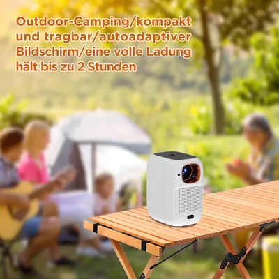A group of people are camping outdoors, with a projector on a table in the foreground.
