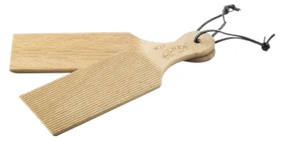 Two wooden butter boards with grooves, one slightly overlapping the other, against a white background.
