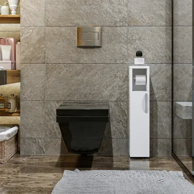 A modern bathroom with a black wall-mounted toilet, a white storage cabinet for toilet paper, and stone-like tiles.