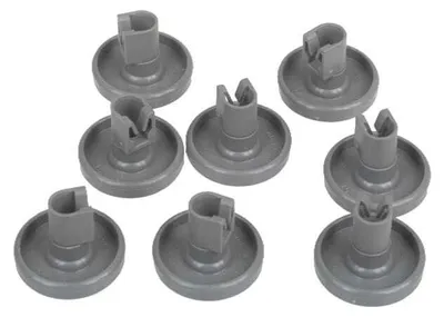 A collection of gray dishwasher basket rollers on a white background.