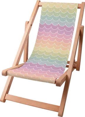 A wooden deck chair with a colorful fabric seat featuring a rainbow fish scale pattern.