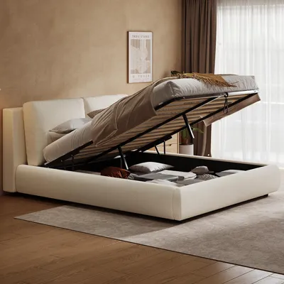 A bed with its storage compartment open, showing items stored inside.