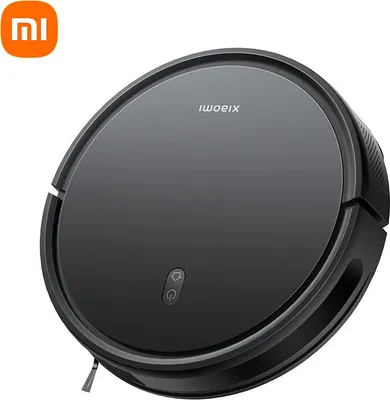 A black Xiaomi robot vacuum cleaner is shown from a slightly elevated diagonal angle against a white background. The Xiaomi logo is visible in the top left corner.