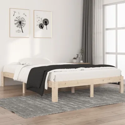 A wooden bed frame with white bedding and a black blanket, placed on a gray rug.