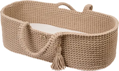 A beige knitted Moses basket with handles and a tassel detail, placed on a white background.