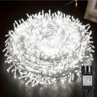 A coiled string of white LED lights with a black power adapter.