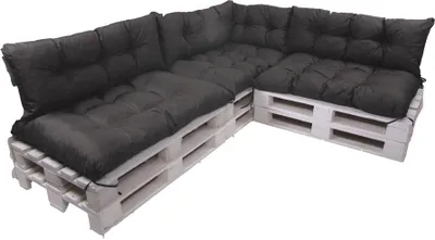 A sectional sofa made from wooden pallets with dark gray cushions, shown against a white background.
