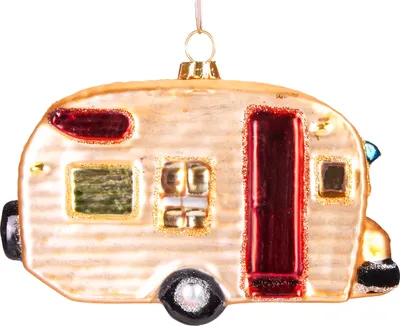 A glass ornament shaped like a vintage camper trailer.