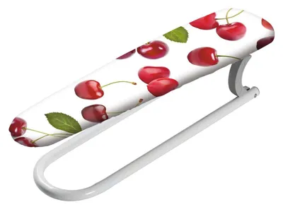 A close-up shot of a small ironing board with a cherry pattern.