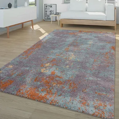 A modern living room with a white dresser, a couch, and a rug.