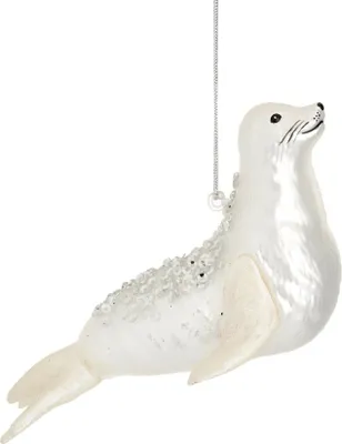 A white seal ornament hanging from a silver chain against a white background.