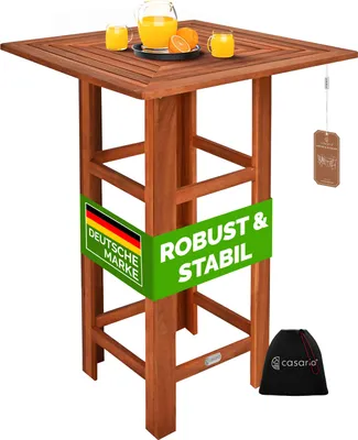 A wooden bar table with drinks and oranges on top, with promotional text on the legs.