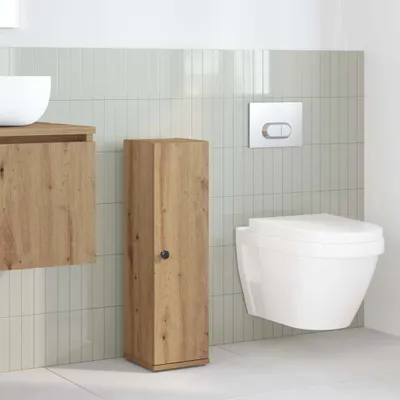 A modern bathroom with a wall-mounted toilet, a wooden vanity, and a tall wooden cabinet.
