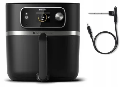 A black Philips air fryer and a meat probe are shown against a white background.