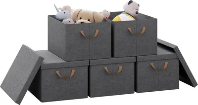 A set of five grey fabric storage boxes with brown handles, some filled with stuffed animals.