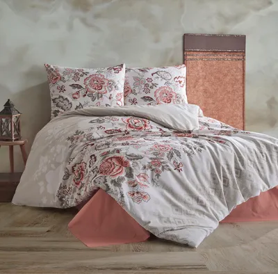 A bed with floral patterned bedding in a room setting.