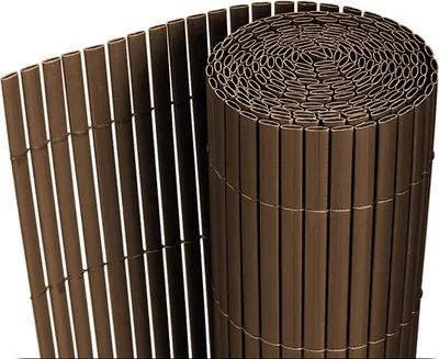 A rolled-up privacy screen made of brown plastic slats.