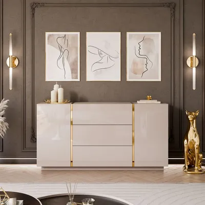 A modern living room with a beige high-gloss dresser, artwork, and decorative items.