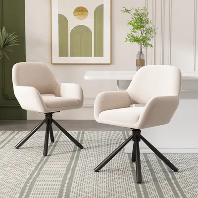 Two beige upholstered chairs with black metal legs are placed on a patterned rug in a dining room setting.