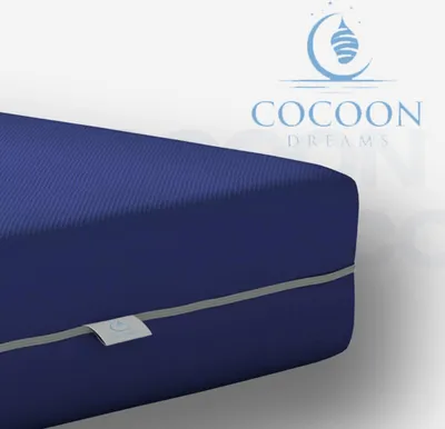 A close-up view of a blue mattress with a gray seam and a small label.