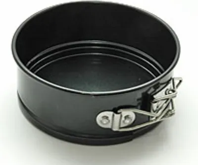A black mini springform pan with silver clasps is shown against a white background.
