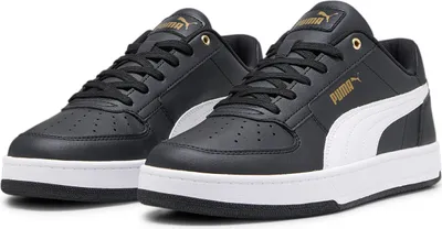 A pair of black Puma sneakers with white accents and gold branding.