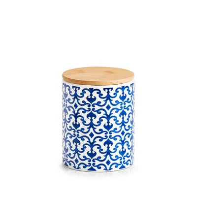 A ceramic storage jar with a blue and white pattern and a bamboo lid, isolated on a white background.