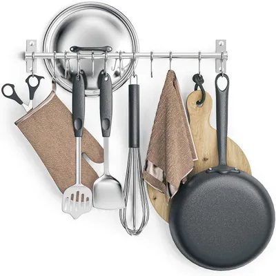 Kitchen utensils and accessories hanging on a rack mounted on a wall.