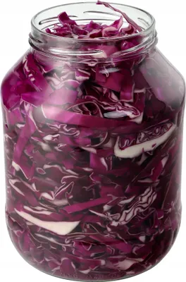 A glass jar filled with chopped red cabbage.