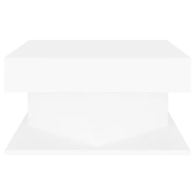 A white, modern coffee table with a geometric base.