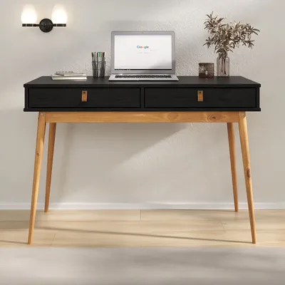 A black and wood desk with a laptop and decorative items.