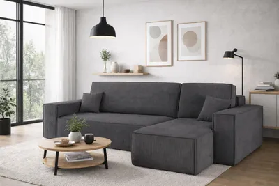 A modern living room with a sectional sofa, coffee table, and artwork.