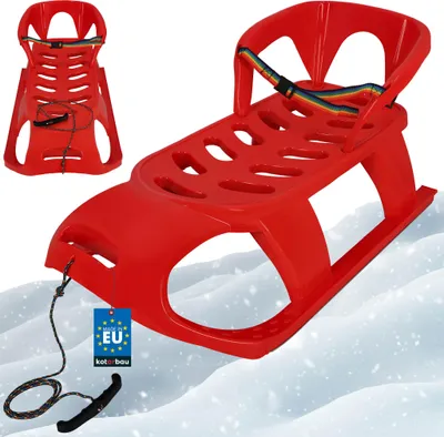 A red plastic sled with a rainbow-colored safety strap and a black pull rope with a handle, resting on a snowy surface.