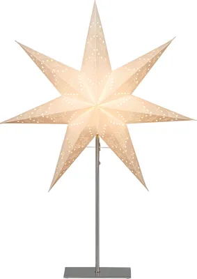 A white, star-shaped paper lamp with small perforations, illuminated from within, standing on a silver metal stand.