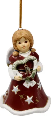 A ceramic angel ornament with a heart-shaped wreath.