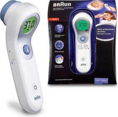 A Braun No Touch + Forehead Thermometer is shown next to its packaging, which displays product features and images of children using the thermometer.