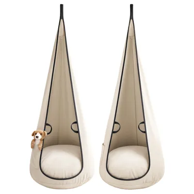 Two beige hanging chairs with black trim are shown against a white background. A stuffed dog is peeking out of one of the chairs.