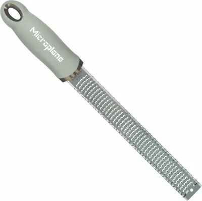 A Microplane grater on a white background.