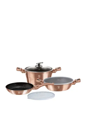 A set of copper-colored pots and pans with black interiors and glass lids, arranged on a white background.