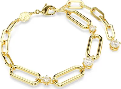A close-up studio shot of a gold-colored bracelet with clear stones.