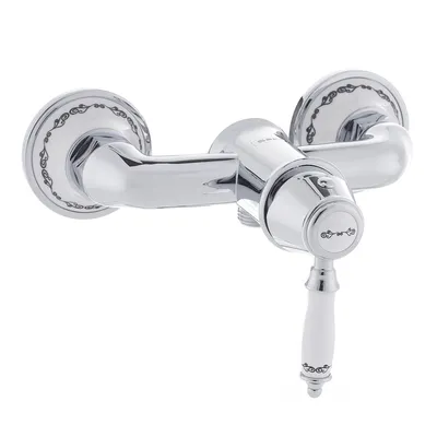 A chrome and white shower faucet with decorative detailing.