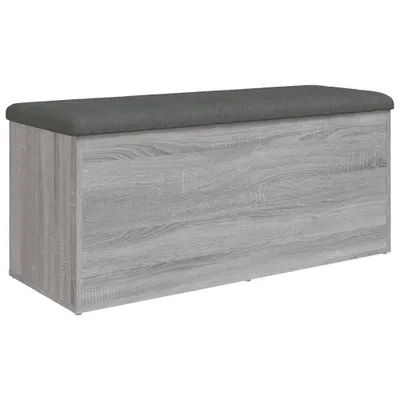 A storage bench with a gray upholstered top and a wood-effect base, shown against a white background.